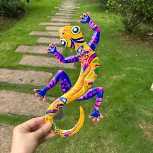 Close-up of colorful metal gecko wall art, vibrant hand-painted finish, ideal for garden decor.