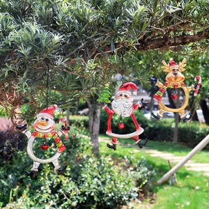 Christmas metal hanging ornaments detail with snowman and Santa figures for holiday decor.