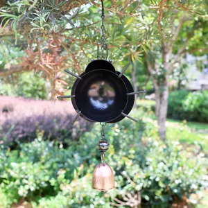 Detailed shot of a 3D metal ladybug wind chime with hanging bell, perfect for garden outdoor decor.