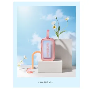 Detail shot of the pink transparent PVC wash bag with portable handle for travel and daily makeup.