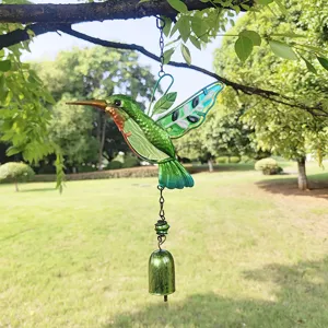 Detailed view of hanging stained glass green hummingbird wind chime garden metal ornament.