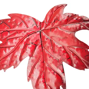 Red metal maple leaf wall hanging with crackle finish, perfect for garden and home decor.