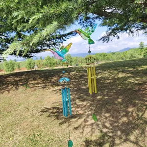 Metal hummingbird wind chime with colorful painted glass, perfect for outdoor garden decor.