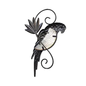 Metal parrot wall decor detail showing the intricate iron scrollwork and textured body inlay.