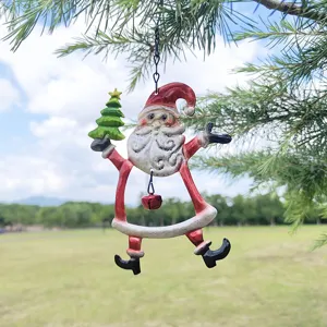 Outdoor hanging Christmas ornament detailed view featuring painted iron Santa with tree.