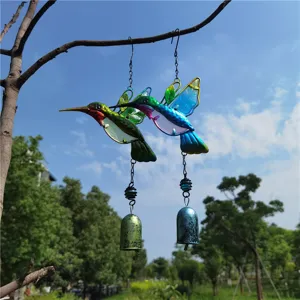 Outdoor hanging metal glass hummingbird wind chime detail shot, vibrant garden decoration bell.