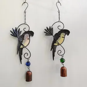 Detailed view of handmade iron parrot wind chimes with glass beads and vintage bells for home decor.