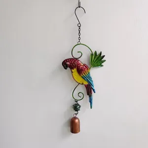 Metal parrot wind chime hanging ornament, colorful handmade garden and home decor detail shot.