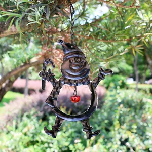 Detailed shot of iron snowman hanging ornament with red bell for Christmas holiday decor.