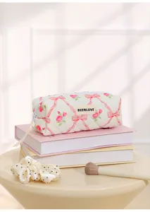 Quilted cosmetic bag with cute pink bow and rose print, soft cotton makeup storage pouch daily.
