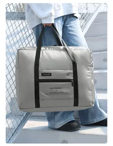 Foldable travel duffel bag detail, portable luggage bag with front pocket and durable handles.