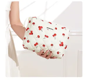 Quilted cotton cosmetic bag with cute cherry print, portable zippered toiletry storage pouch.