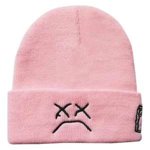 Pink knit beanie for autumn and winter featuring embroidered sad face design and cuffed styling.