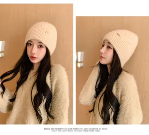 Detailed close-up view of the cozy knit beanie hat worn by the model, perfect for winter.