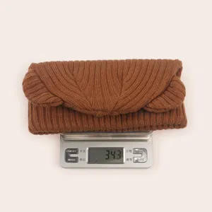Infant cute bear ear knitted hat winter warm stretchy beanie detail showing soft brown fabric.