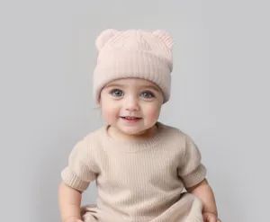 Infant bear ear knit hat detail view, soft cozy warm baby beanie in light pink color.