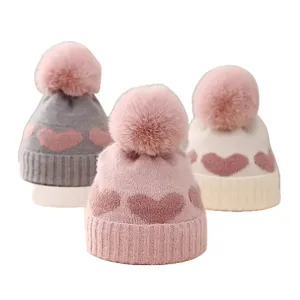 Baby winter knitted hat with cute heart pattern and fluffy pompom, soft thick infant beanie