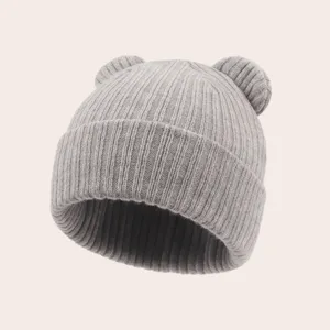 Detail view of grey knitted baby beanie with cute bear ears, soft ribbed texture for autumn.