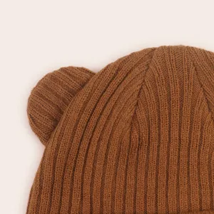 Close-up of brown knit baby hat with cute bear ears, soft texture for autumn and winter.