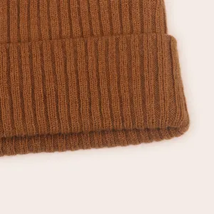 Brown ribbed knit baby beanie hat detail close-up, soft stretchy winter infant headwear
