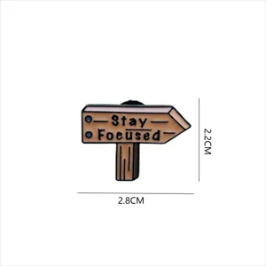 Enamel pin featuring a creative wooden signpost design with English text print, durable finish.