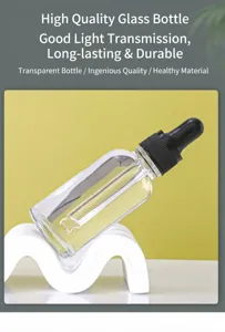 Detailed view of a clear glass essential oil dropper bottle on a wavy white stand