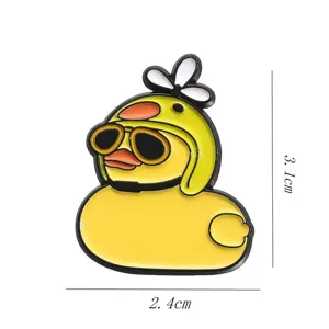 Close-up detail of the cute little yellow duck metal brooch with sunglasses and propeller helmet.