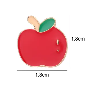 Close up of a cute red apple enamel pin badge with green leaf, ideal detail accessory.