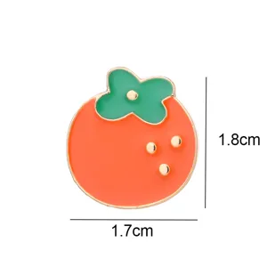 Close-up detail view of the cute persimmon enamel pin, showcasing exquisite coloring and edges.