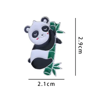 Close-up detail shot of cute panda climbing bamboo enamel brooch pin, metal alloy craft.