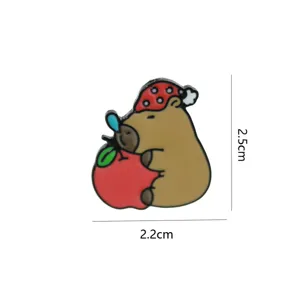 Cute capybara enamel pin brooch with apple and nightcap, metal clothing backpack accessory detail view.