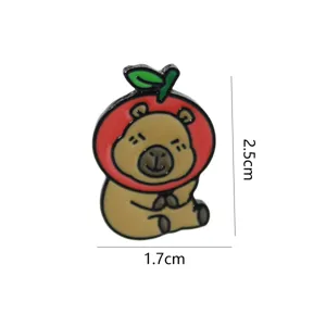 Detailed closeup of the cute capybara enamel pin featuring a red apple hat design.