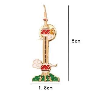 Close-up detail view of Chinese architectural landmark enamel brooch pin, delicate metal craft.