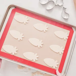 Stainless steel Easter cookie cutter set with silicone baking mat for carrot shaped cookies.