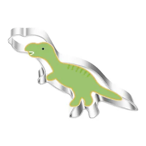 Stainless steel dinosaur cookie cutter with green comfort grip baking tool for DIY biscuits.