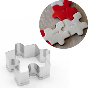Stainless steel puzzle piece cookie cutter detail shot showing smooth edges and baking usage.