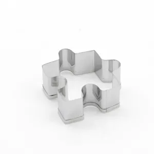 Stainless steel puzzle shaped cookie cutter detail, perfect for baking and fondant tools.