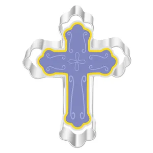 Stainless steel cross cookie cutter detail, decorative purple pastry baking mold close up.