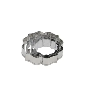 Stainless steel cookie cutter detail view, nested scalloped round shape for baking.