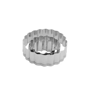 Stainless steel scalloped pastry cutter detail, nesting baking tool close-up view.