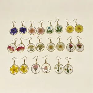 Handmade dried flower resin round earrings with botanical plant leaves and golden hooks for women.