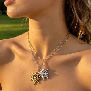 Close-up detail of layered sun pendant necklaces in gold and silver, elegant celestial jewelry.