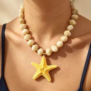 Closeup detail of a bohemian style yellow starfish pendant necklace with chunky acrylic beads.