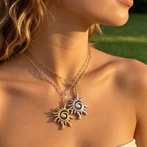 Detailed shot of double layered sun pendant necklaces featuring gold and silver tones.