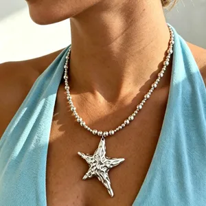 Stainless steel beaded necklace with an exaggerated irregular star pendant for women.