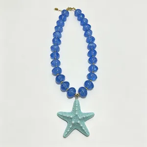 Detailed view of the blue acrylic starfish beaded necklace, showcasing beach summer style.