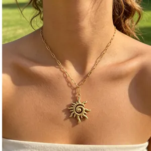Close-up view of the chic gold stainless steel paperclip chain with a sun spiral pendant.