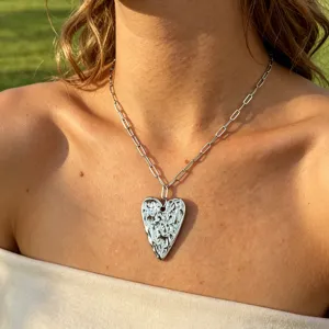 Stainless steel heart pendant necklace detailed view, modern paperclip chain jewelry style.