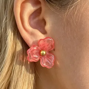 Close-up detail shot of cute floral resin stud earrings with gold bead center, sweet petal design.