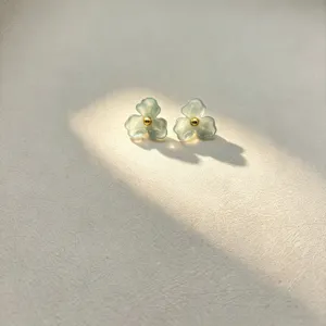 Resin flower stud earrings featuring a chic three-petal design with a gold center bead detail.